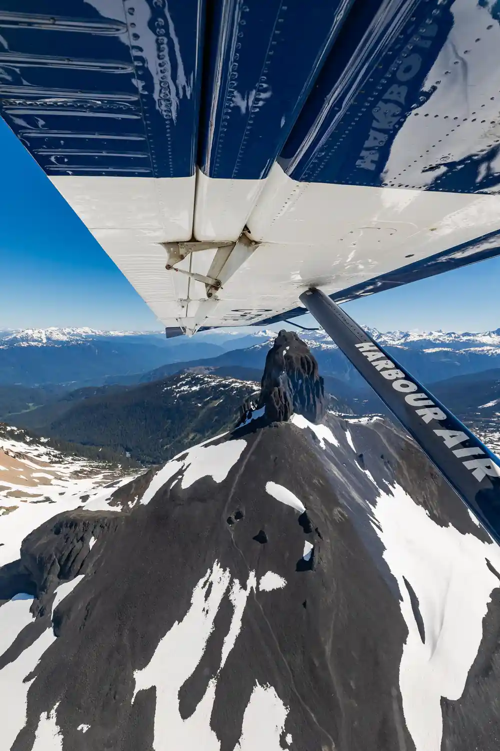 The Black Tusk close from the air, snow on its flanks
