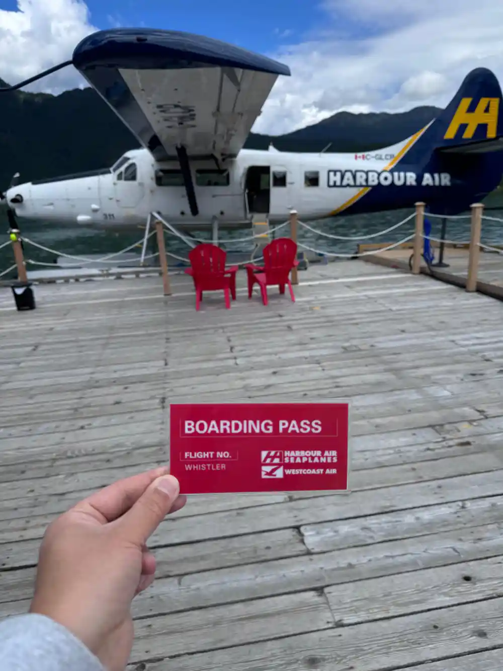 A boarding pass held up at the seaplane dock