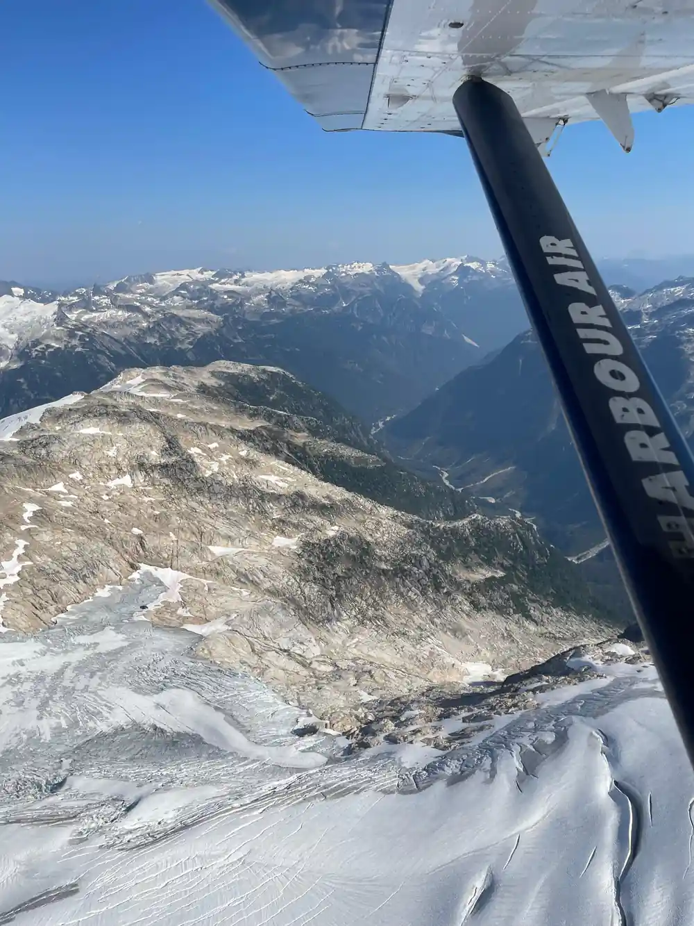 A glacier and its meltwater below the wing