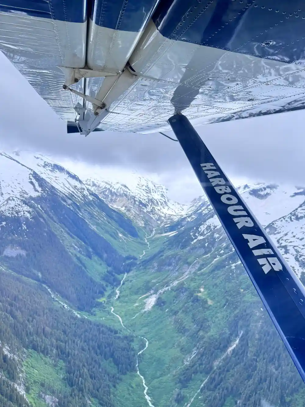 A green valley between snow-topped ridges