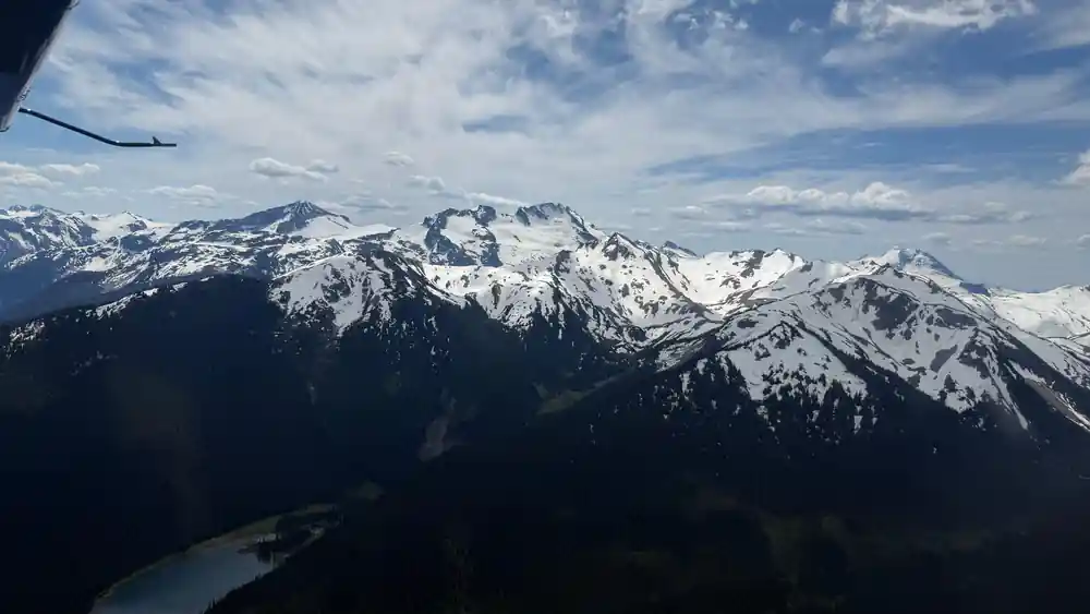 A long snow-covered ridge under cloud