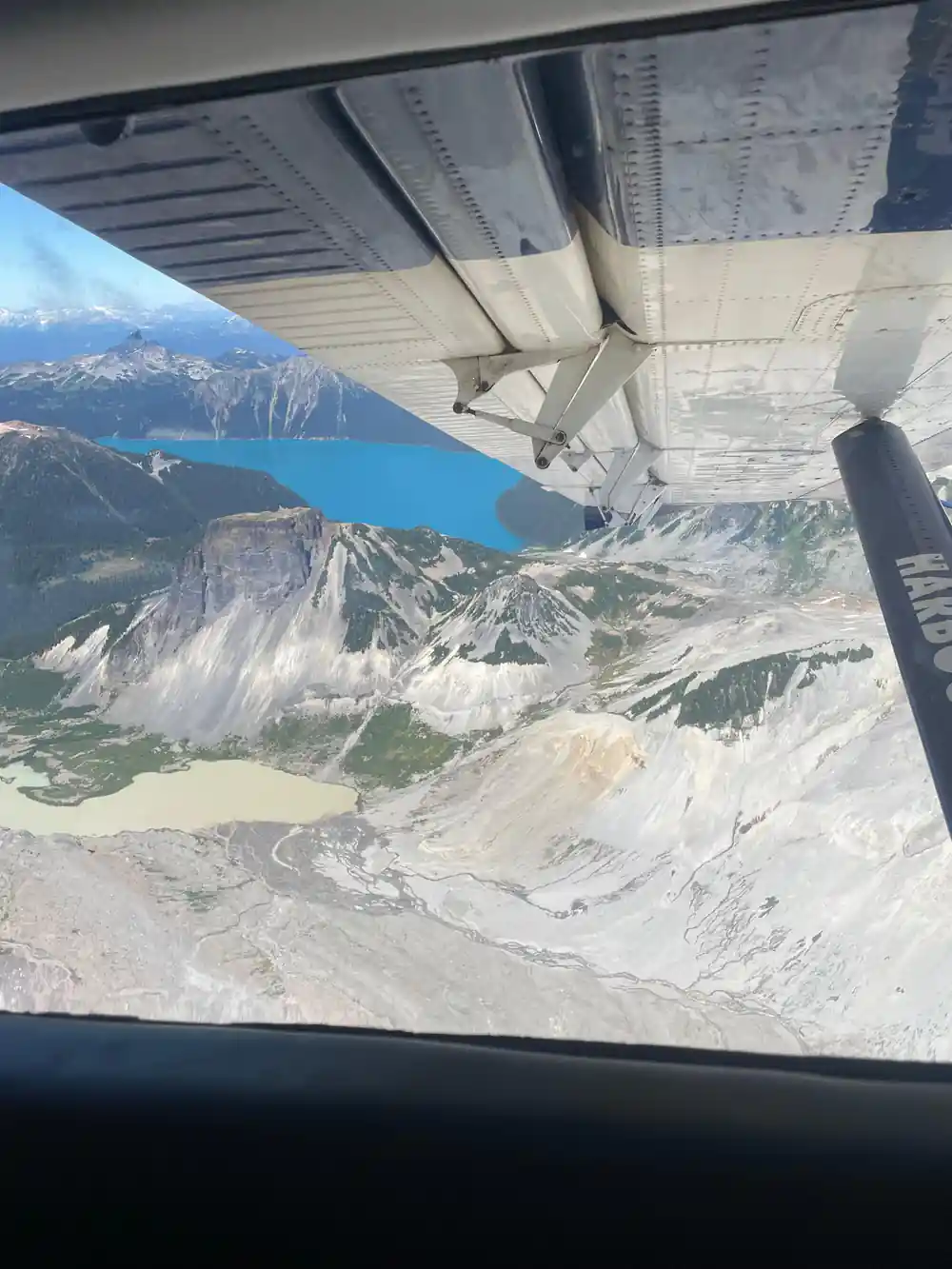 A pale scree basin and a small lake below