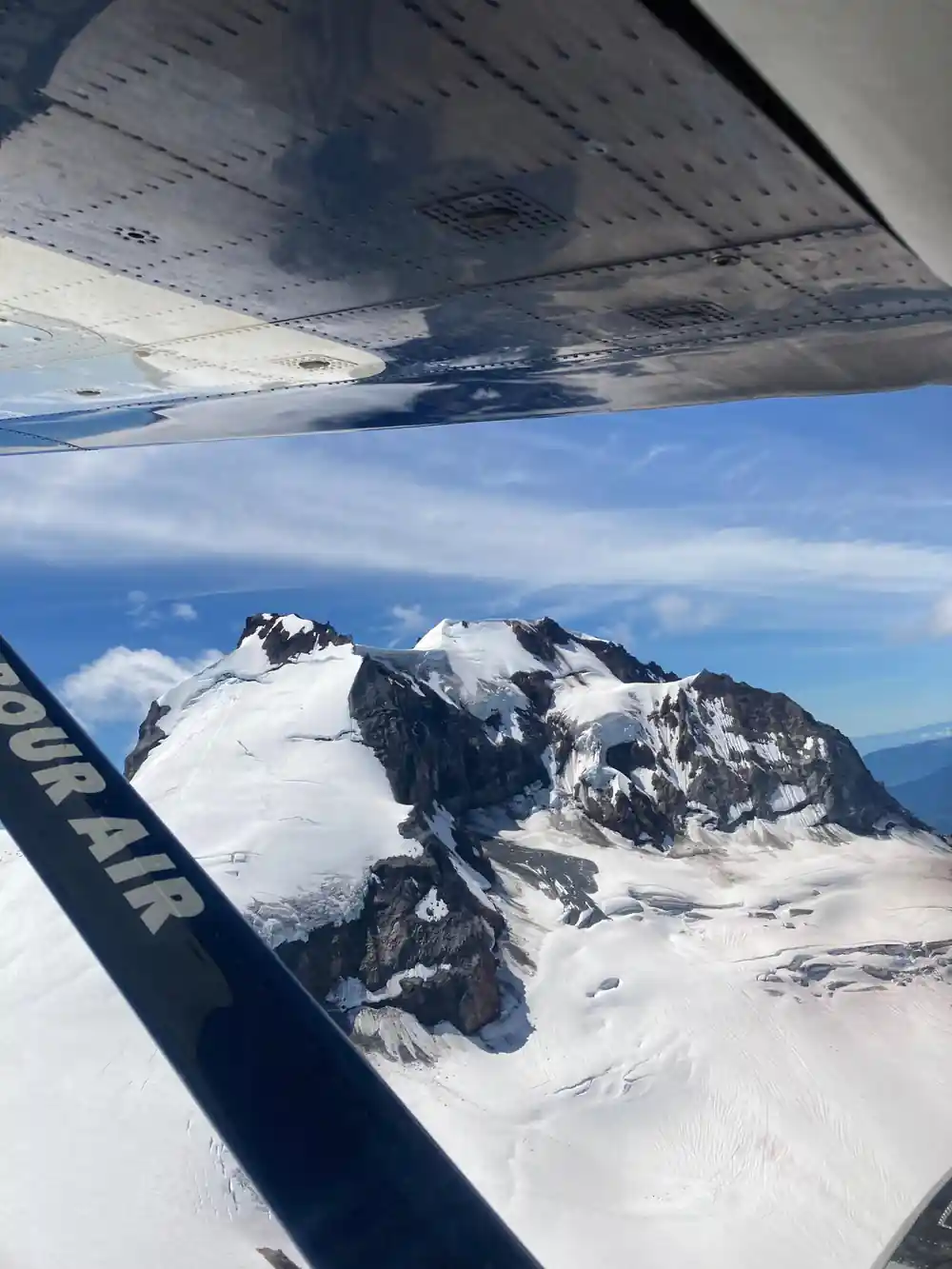 A snow-covered peak seen through the cabin window