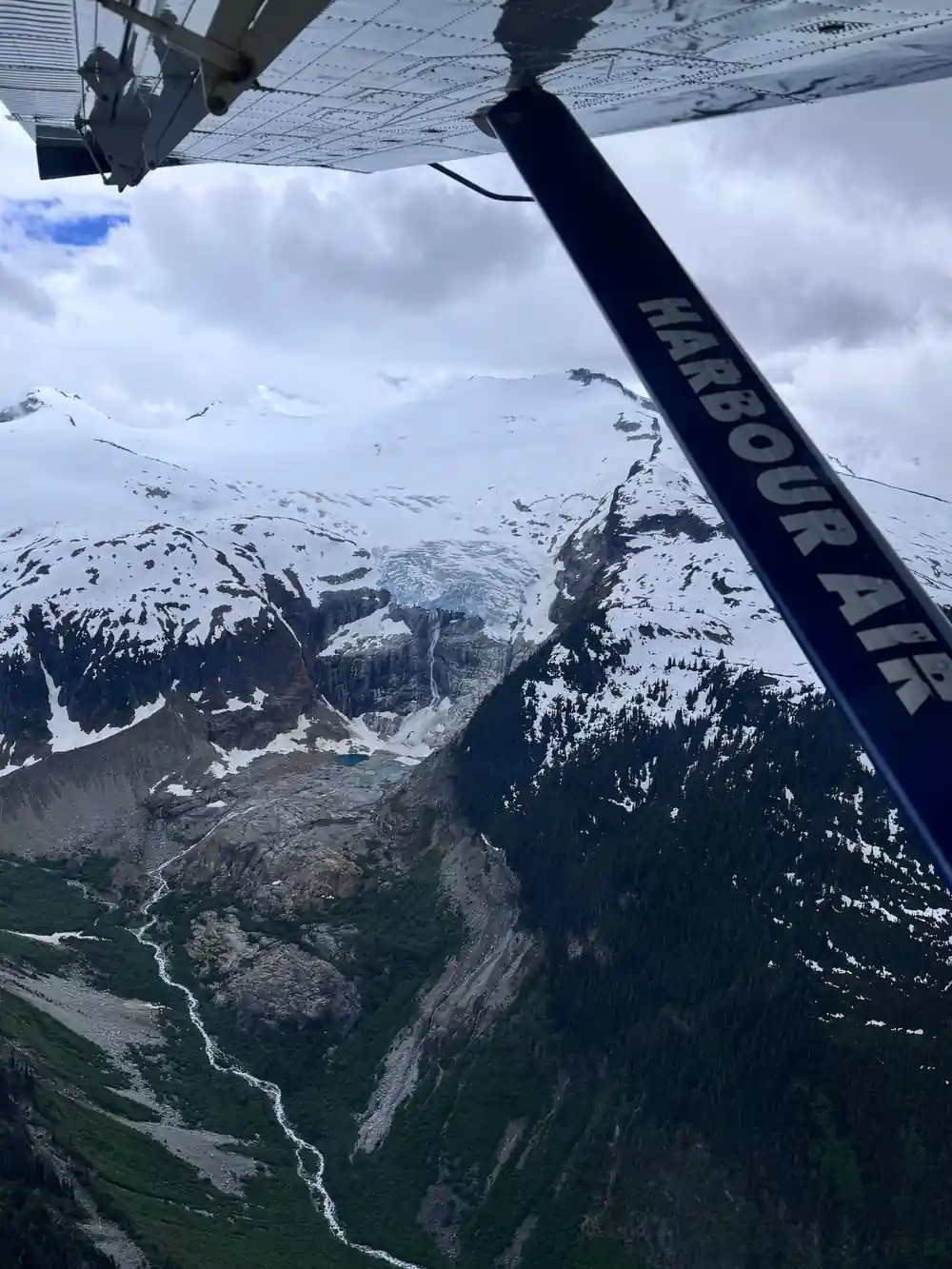 Snowfields and a rock face seen from the wing