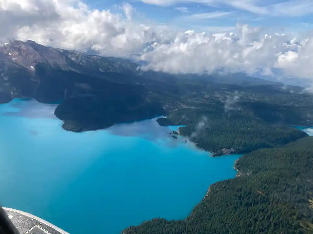 Turquoise lake water below broken cloud